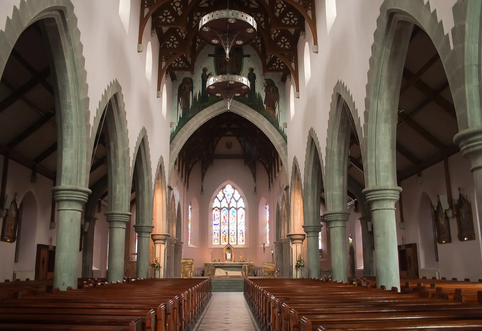 Nave of St. Michael's Church, looking south-east. The painting above the chancel arch depicts the Trinity…