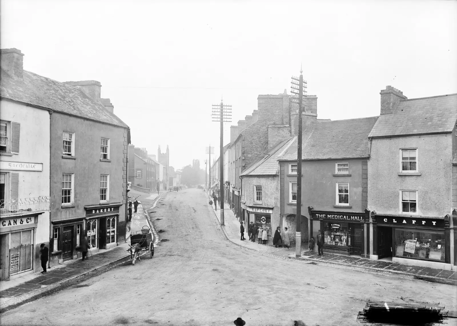An Eason image of Main Street, Ballinasloe in Co. Galway on a quiet day. Lots of pedestrians about but no…