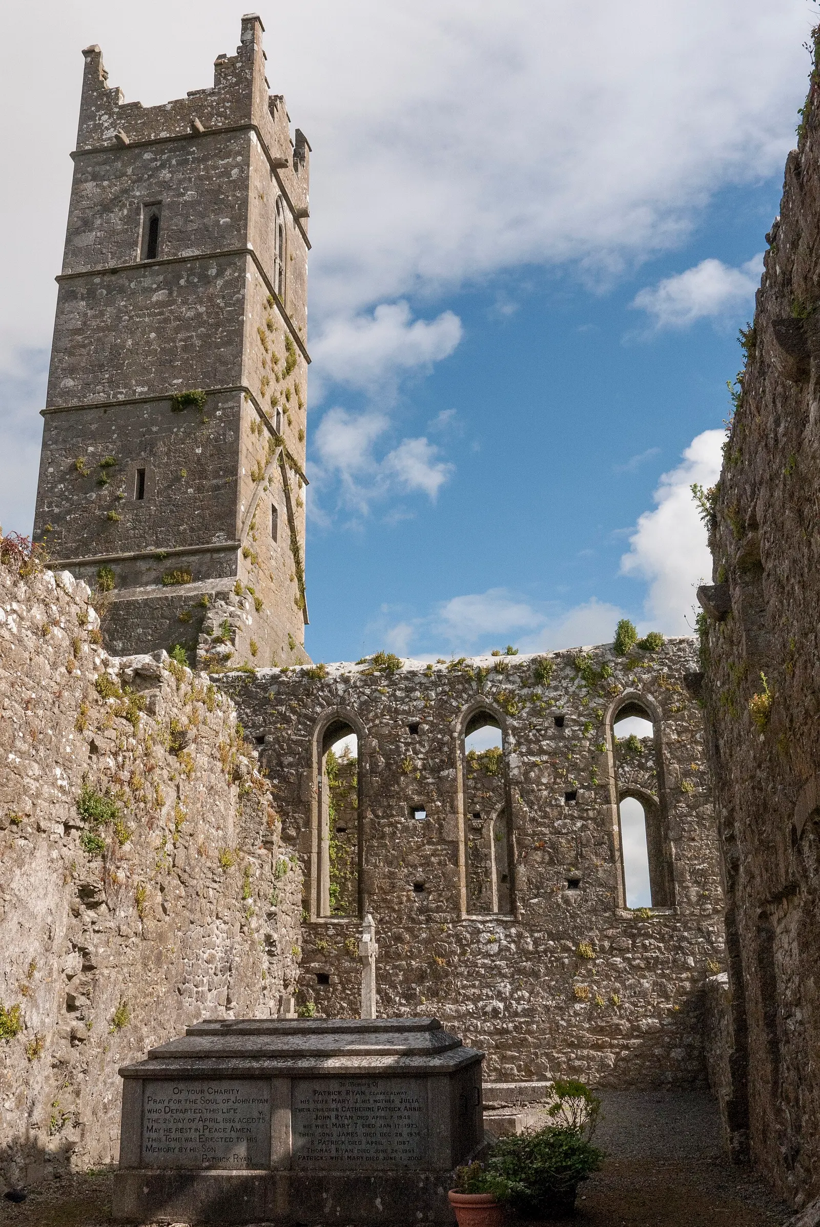 19th Century tomb with the Claregalway Abbey ruins in the background.