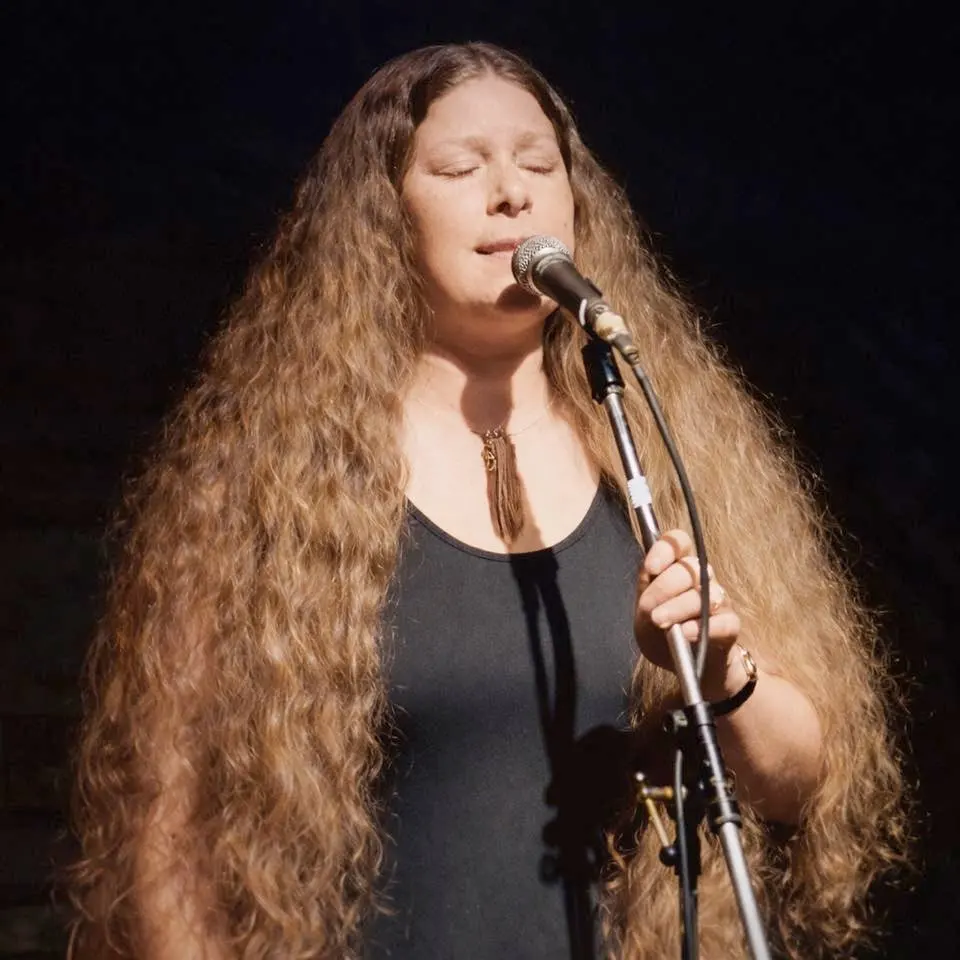 Irish singer Dolores Keane with De Dannan, Irish folk band at the Trowbridge Folk Festival, 1985 (restored and colorised image). Photo credit: Tony Rees