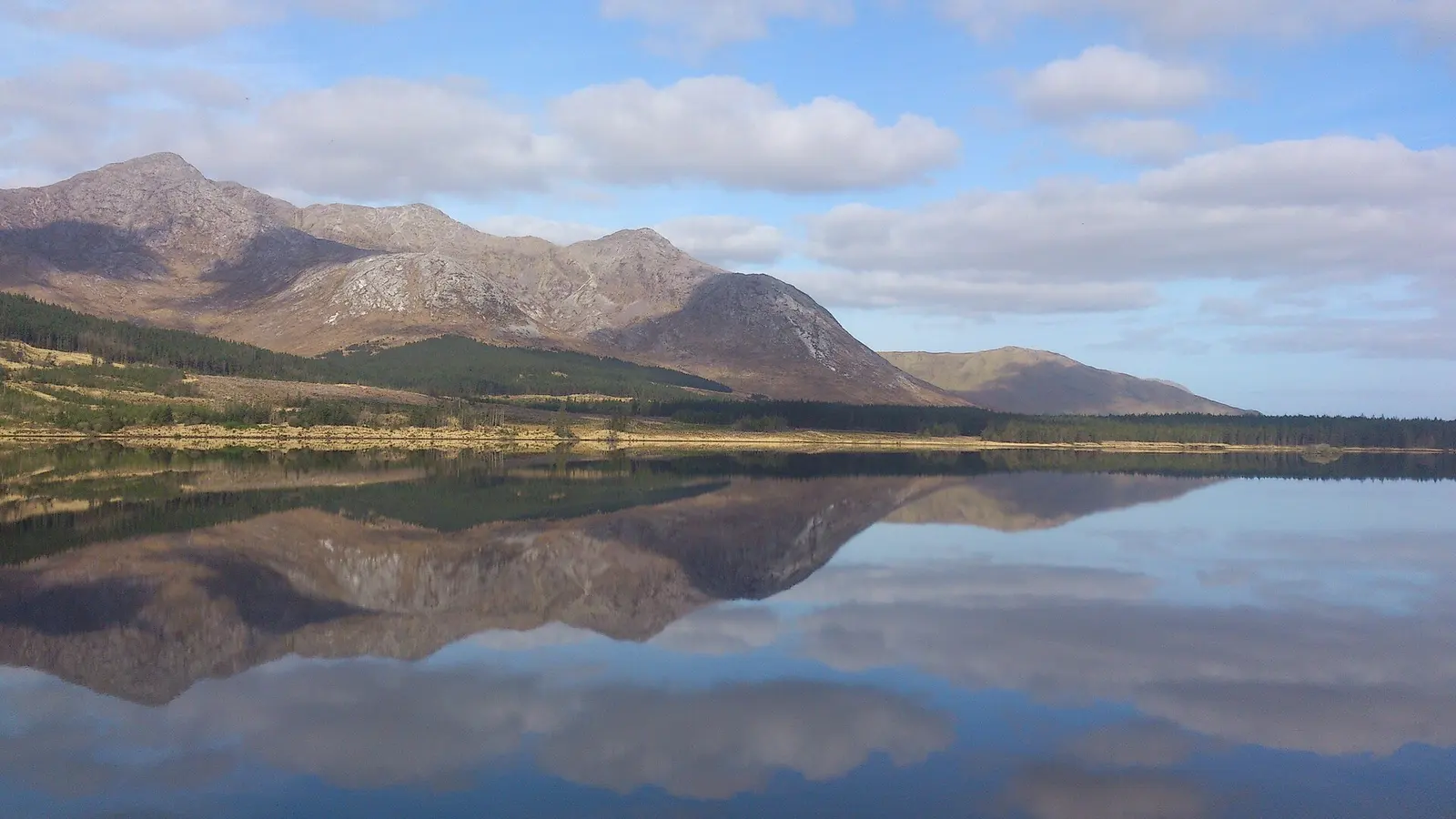 Twelve Bens summits of Bencorr and Benncorr North Top, and also showing Bencorr's two easterly spurs, from Lough Inagh.  Mountain in the far background is Benba