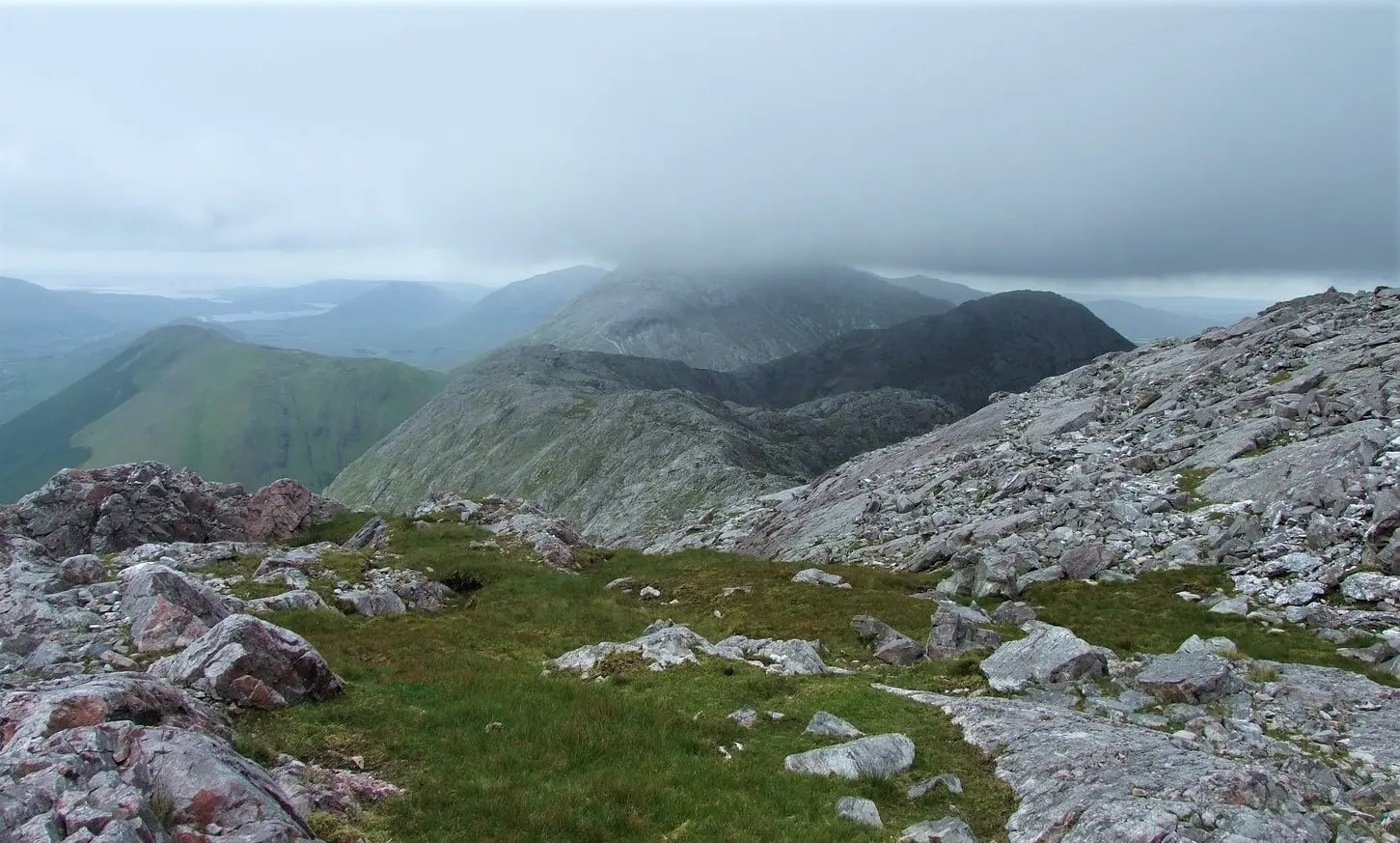 View south to Knocknahillion (in shade) from Letterbreckaun, Maumturks, Ireland. Binn idir and da Log is in the centre at back.